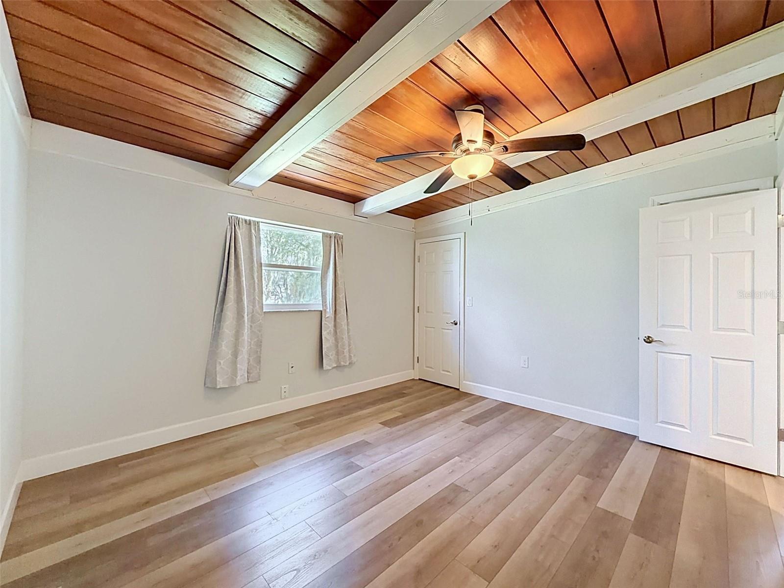 • Bright secondary bedroom with clean coastal finishes.