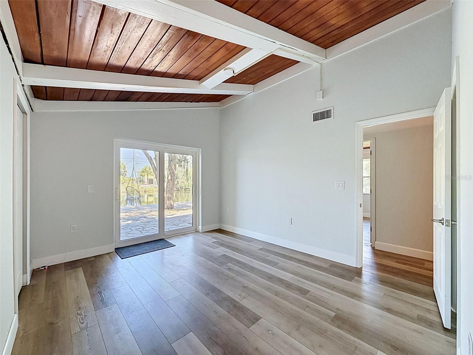 Large primary suite with peaceful natural light and direct access to the outdoor living area.