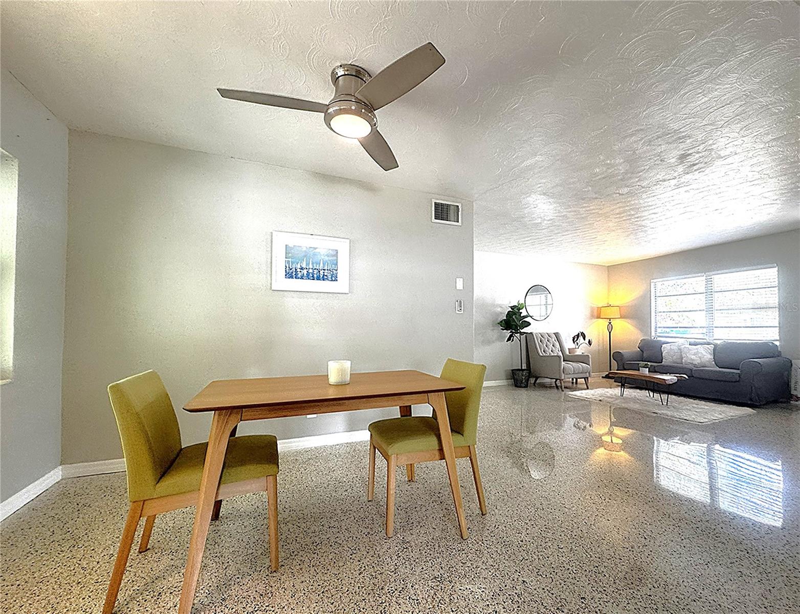 Dining room with view of living room in background.