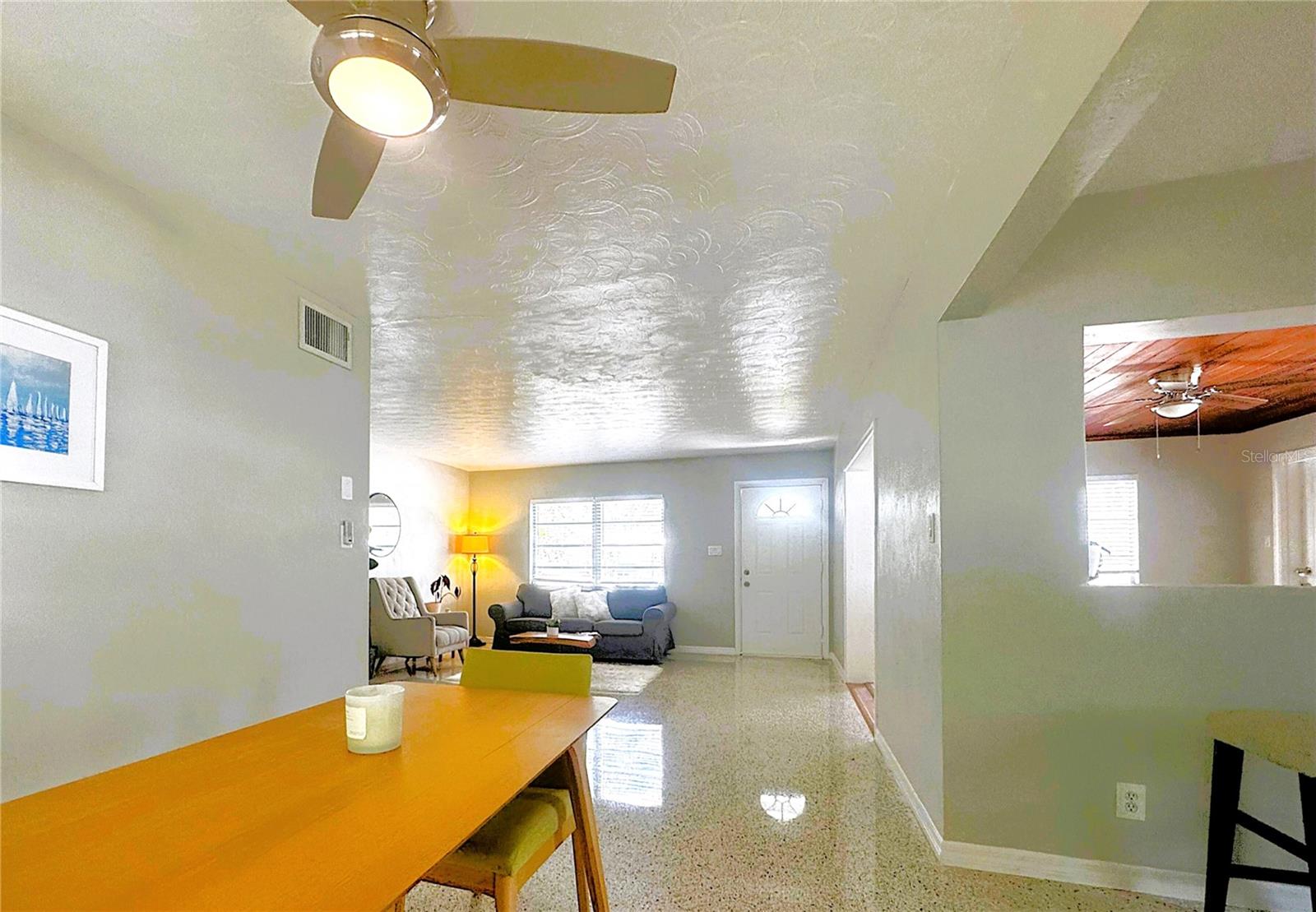 Dining room, with living area to back left and bonus/flex room to back right.
