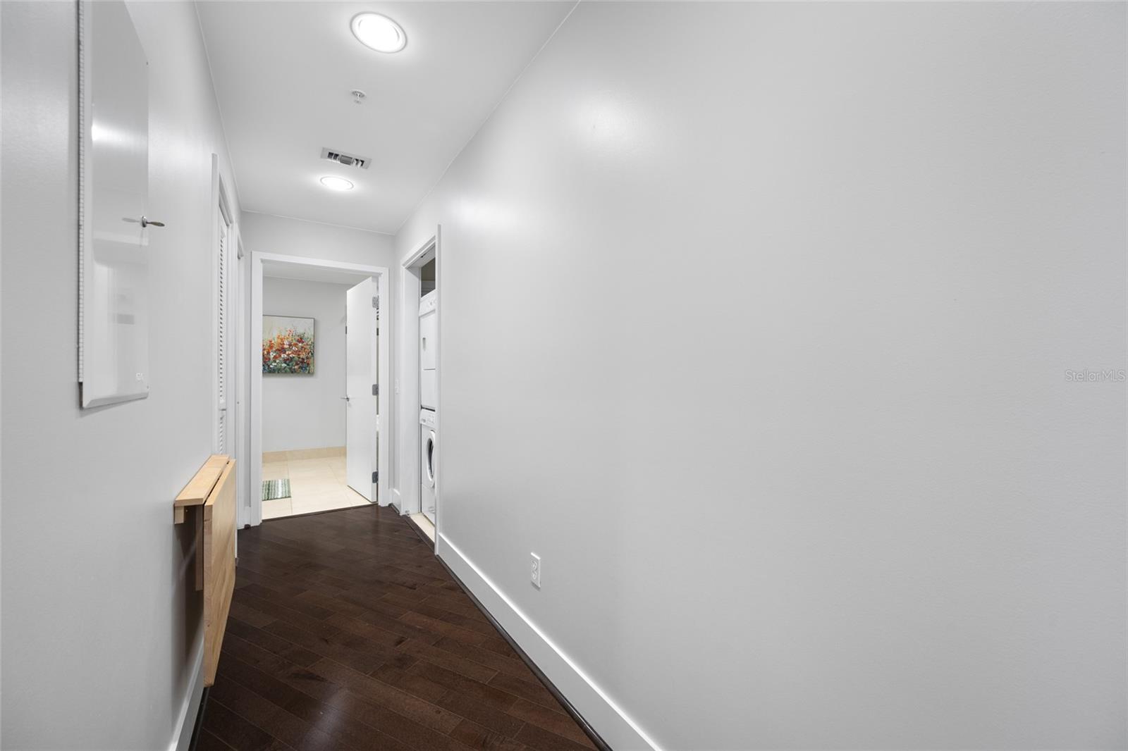 Hallway to primary bath and laundry