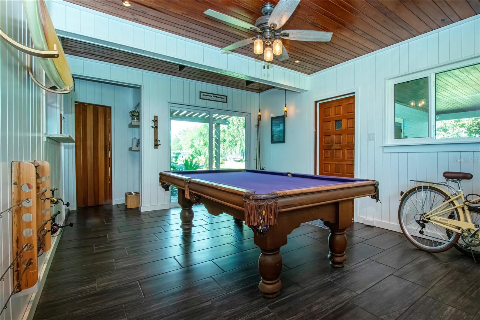 View of the game room new sliding glass doors leads to patio with pavers