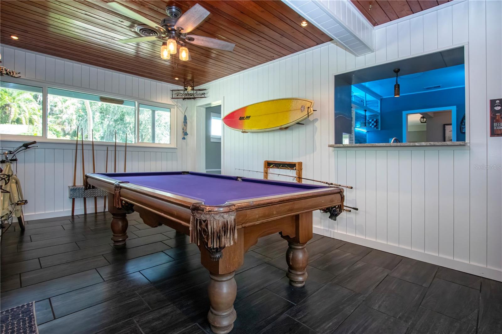 Gameroom with view of pass through windeow in kitchen