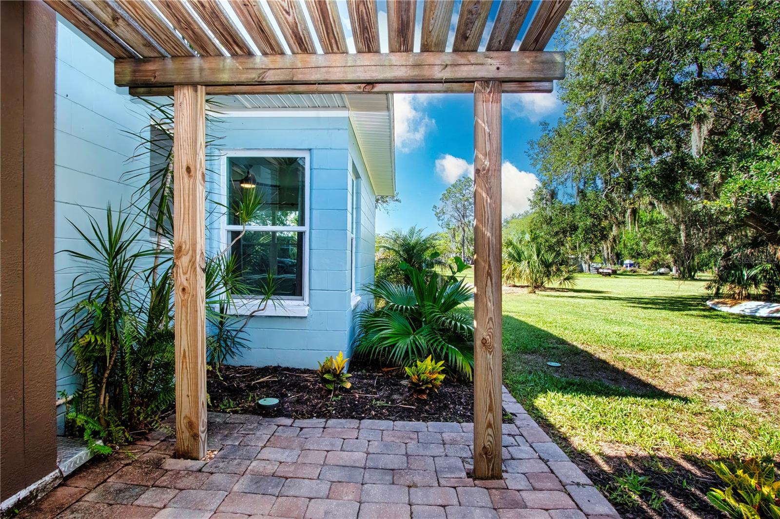 Patio outside the game room covered with trellis and pavers