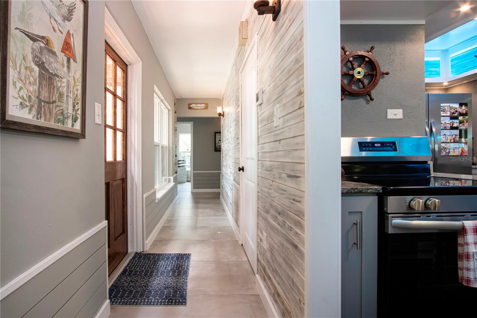 Hallway with door leading to the side patio
