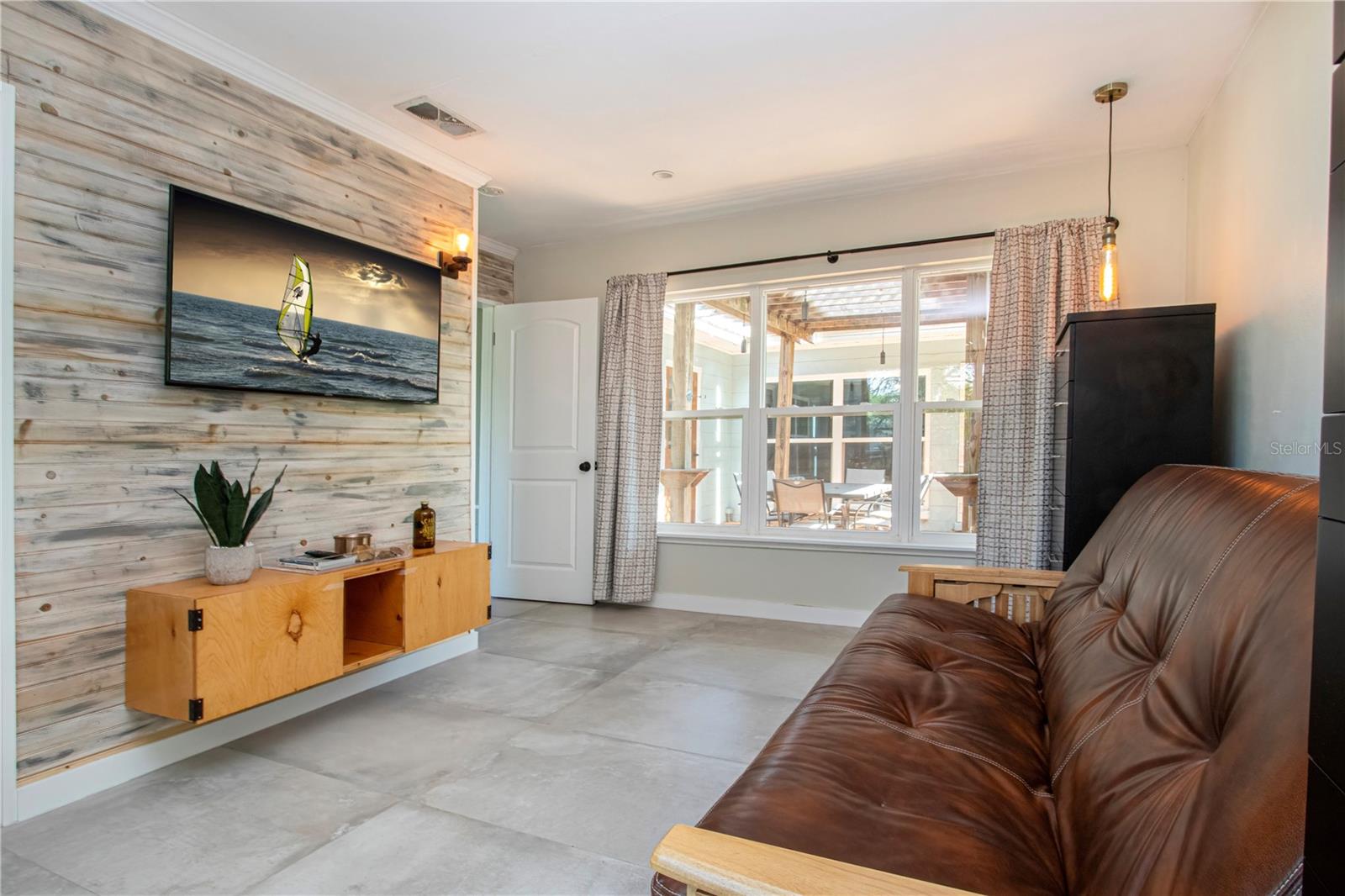 Bedroom 2 with tasteful accent wall and oversized window