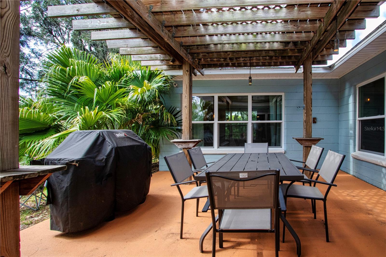 Side patio with freshly painted slab under the pergola