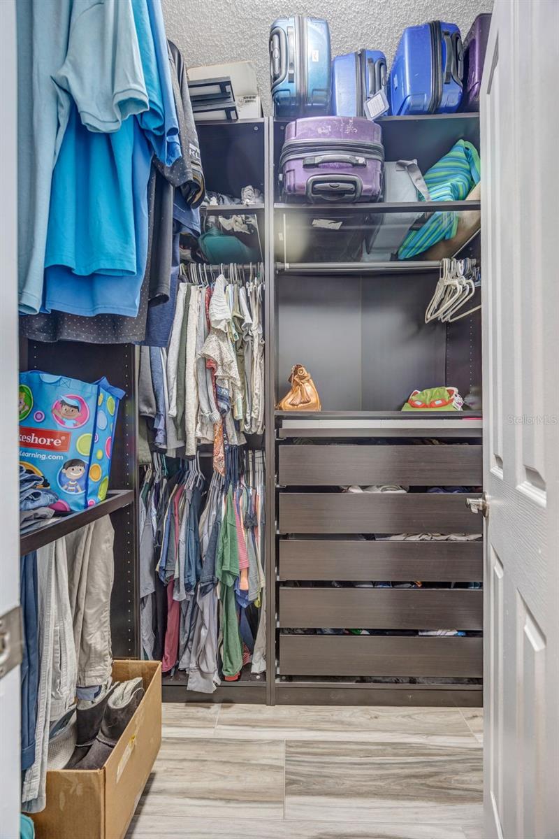Primary closet with custom shelving system.