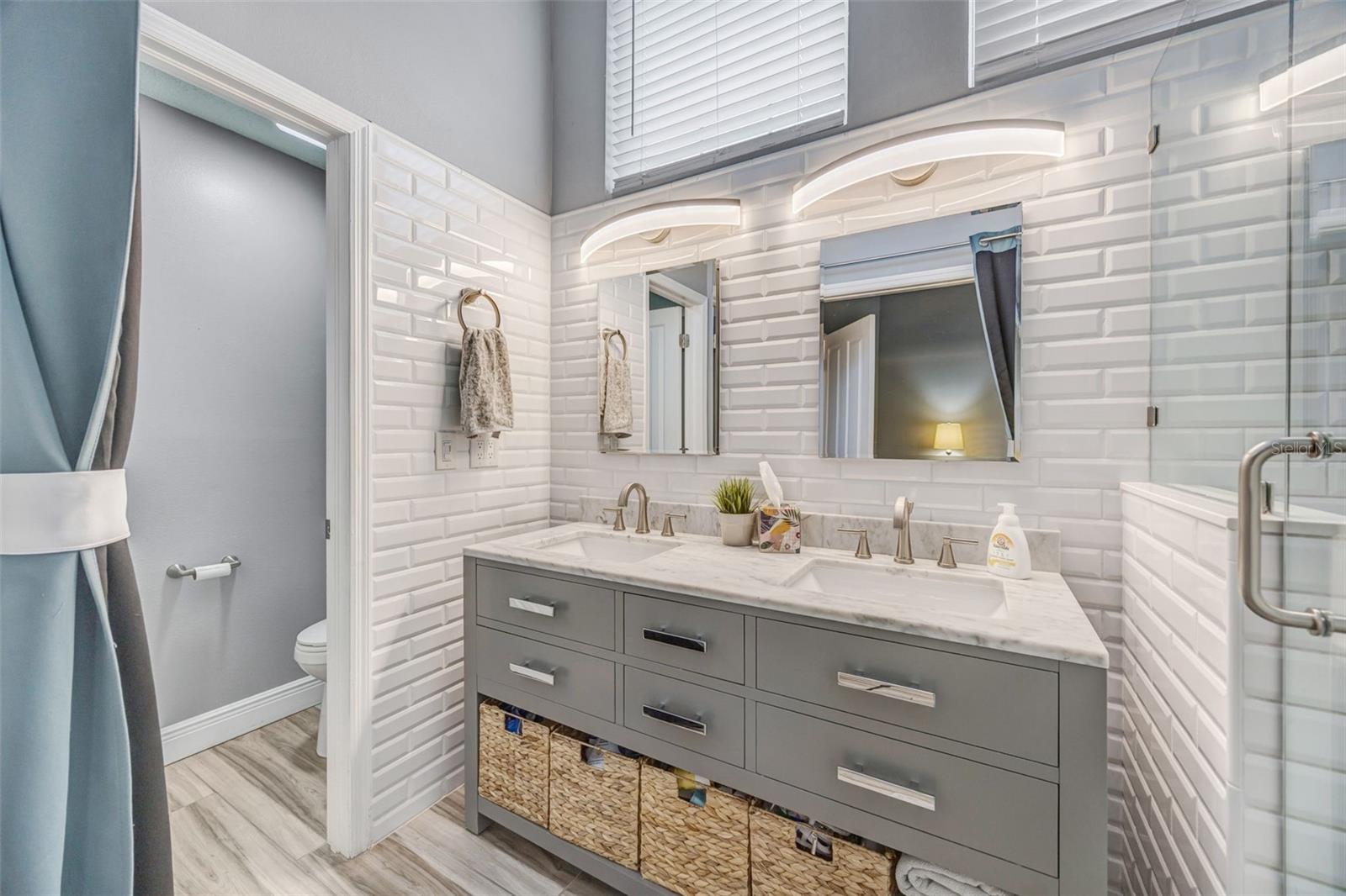Updated en-suite bathroom with dual sink vanity.