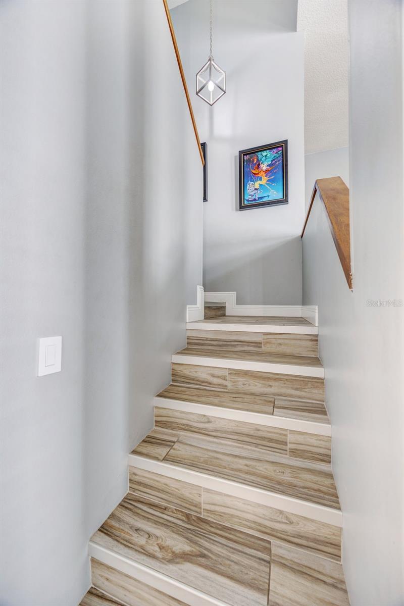 Wood grain ceramic tile stairway.