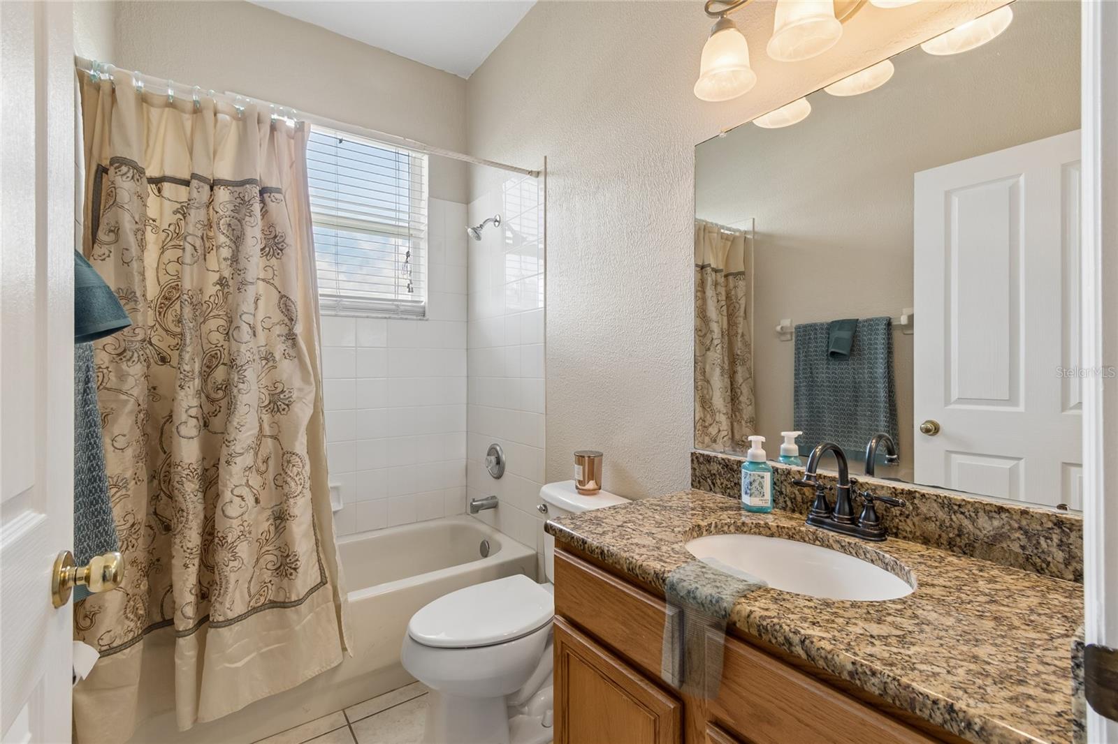 Full Bath features Granite Counter top and window