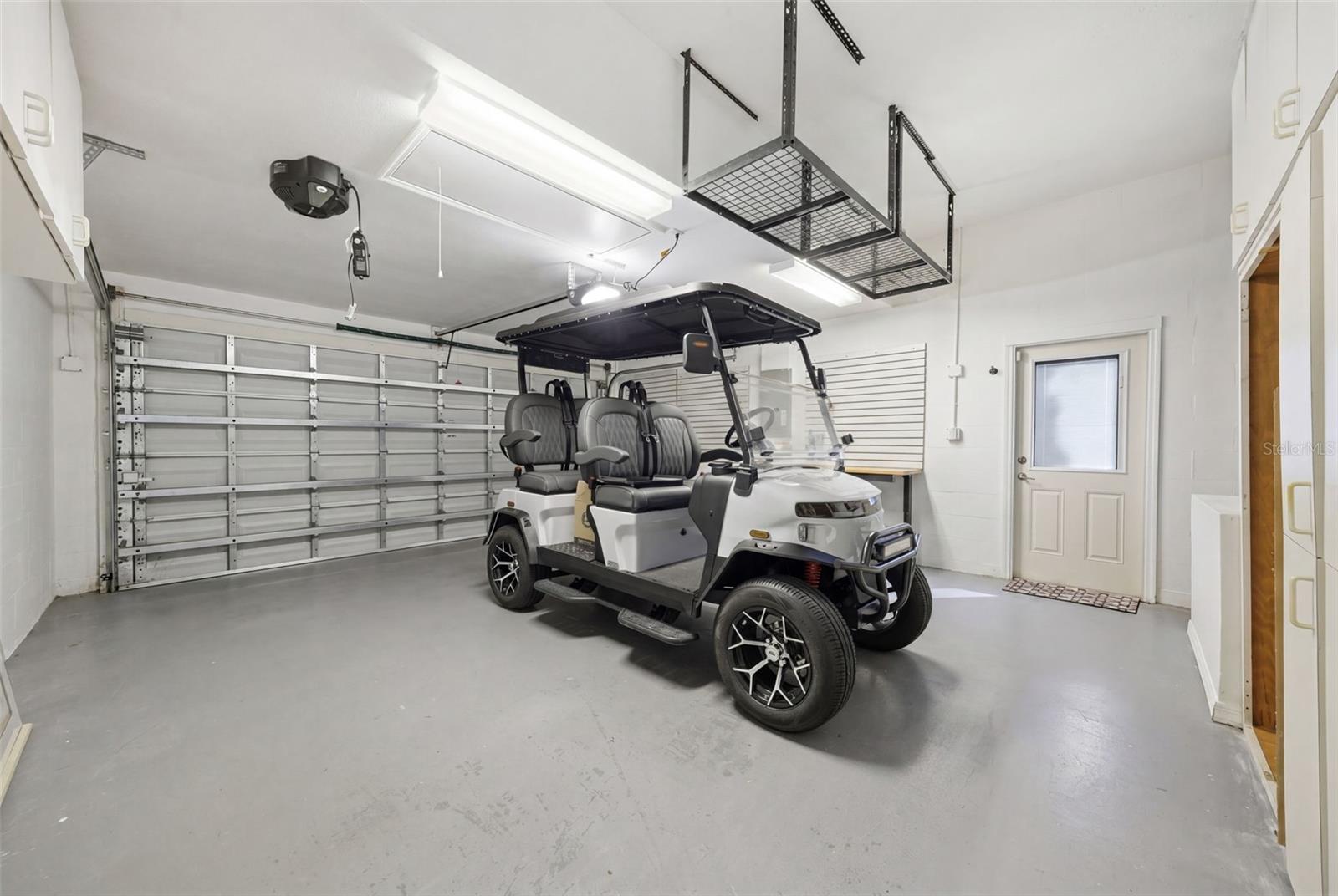 GARAGE HAS CABINETRY AND OVERHEAD STORAGE. EAST LAKE WOODLANDS IS A GOLF CART FRIENDLY COMMUNITY. (golf cart not included)