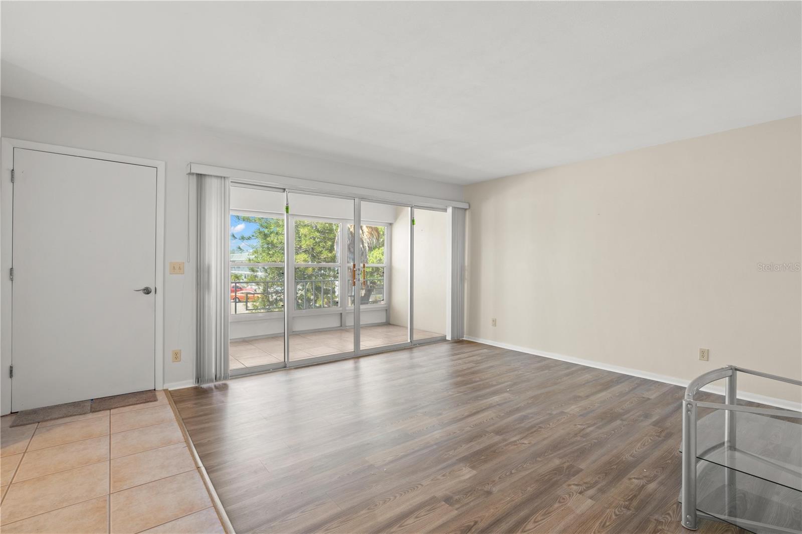 Living Room with wall of sliders to oversized lanai