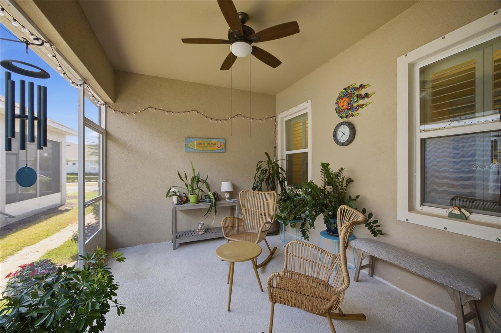 Screened lanai with ceiling fan.