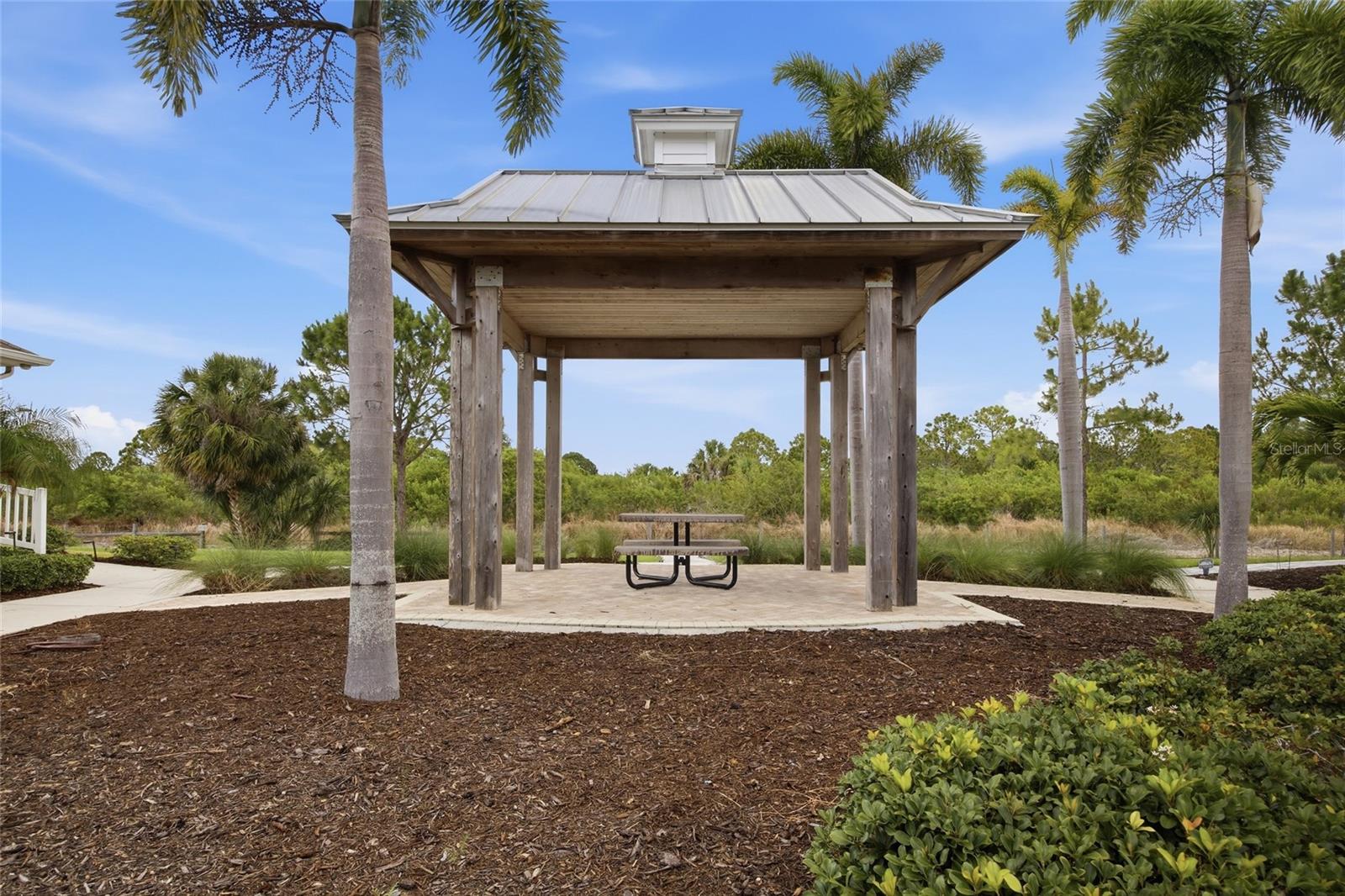 Front yard parklike gazebo overlooking a conservation area with walking trail.