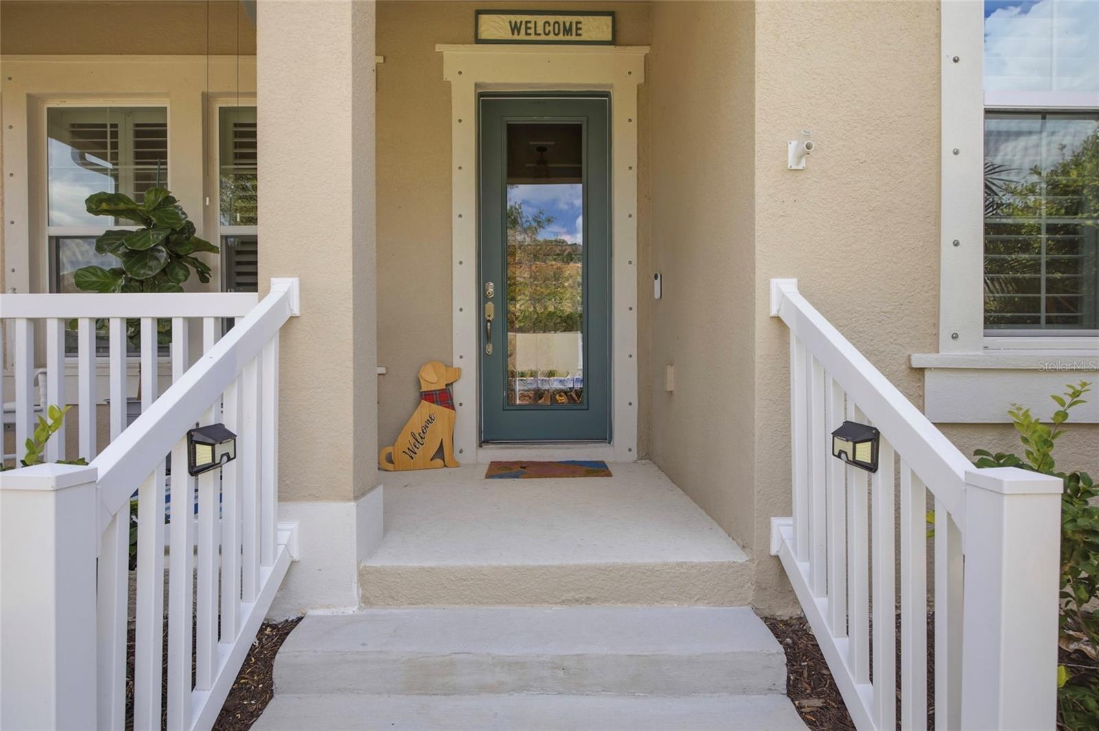 Beautiful entry door says Welcome Home.