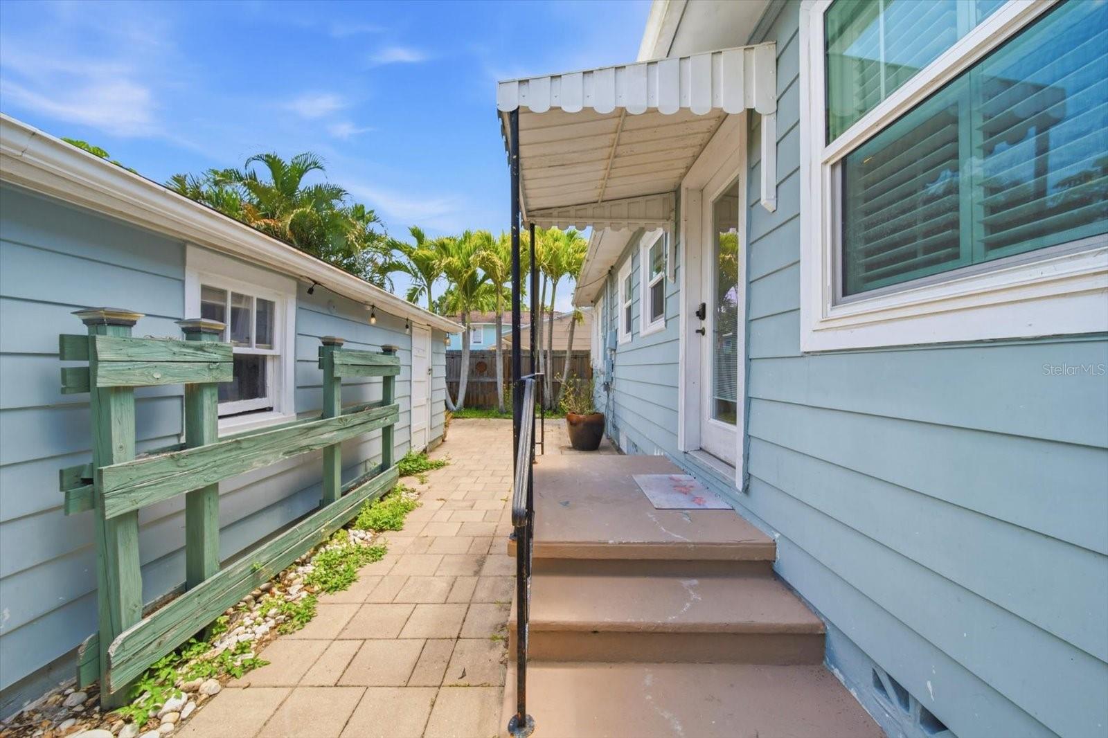 Back Door, open porch steps down to pavers that lead to the yard, garage, or exit to the street/parking