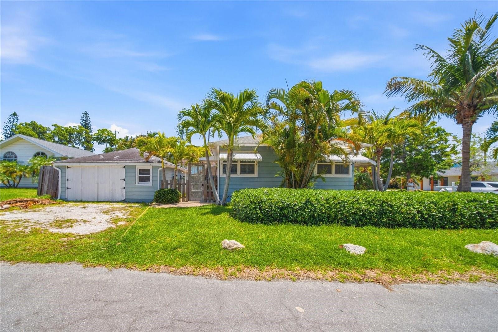 Corner Lot, Detached Garage (or workshop or art studio, you decide) lush greenery, Coconut Trees and Foxtails, oh yes!