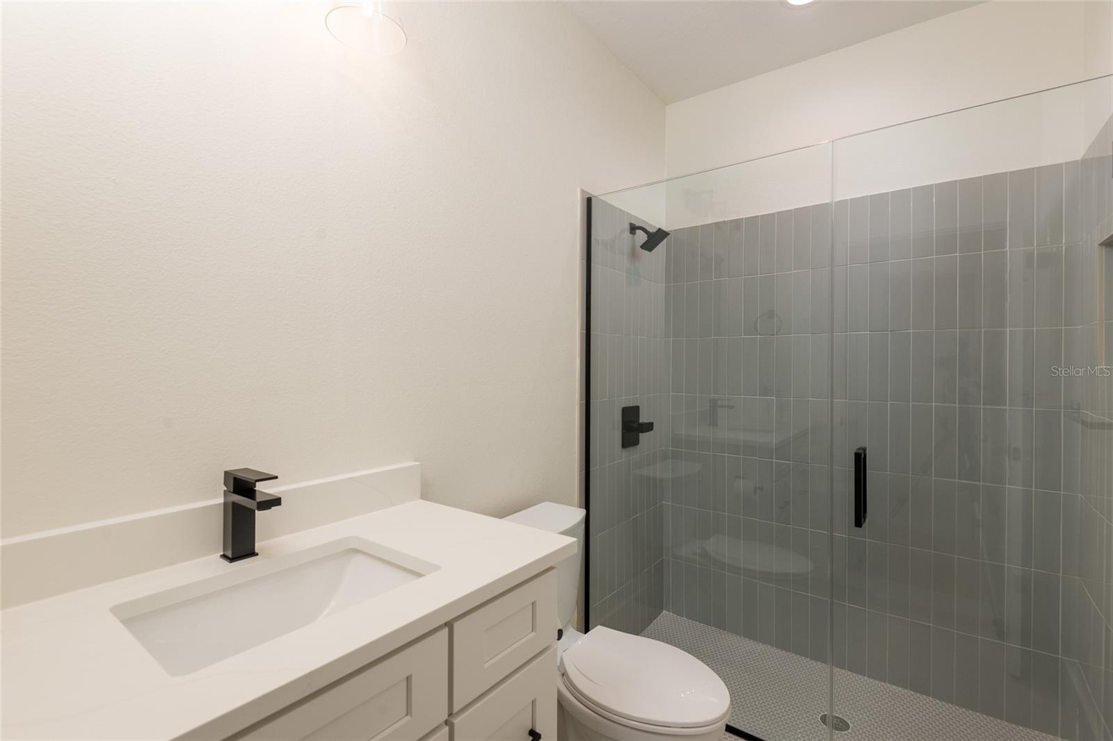First floor bathroom with walk-in shower has close access to outside making it an ideal pool bath.