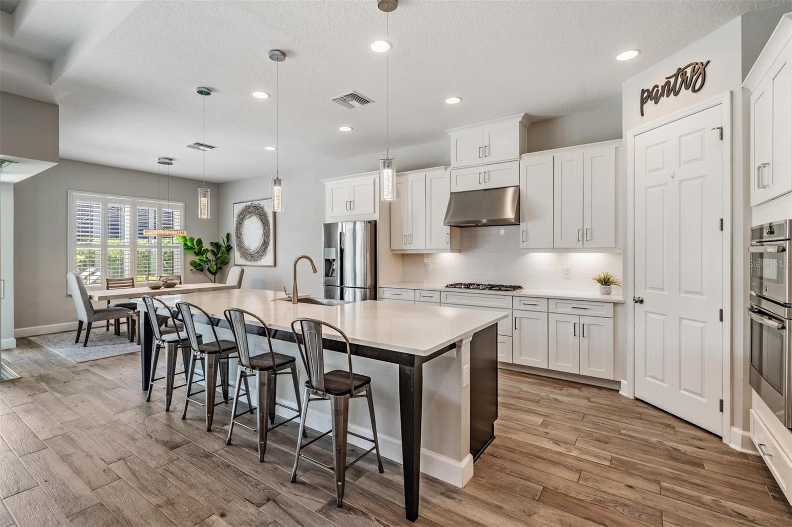 Crisp, white kitchen with breakfast bar seating