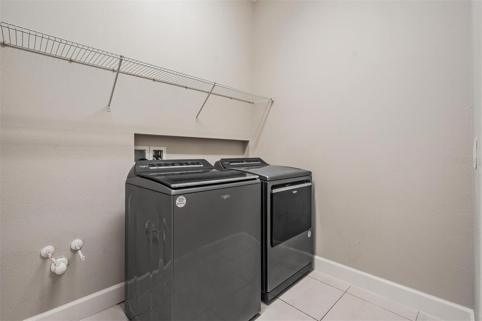 Walk-in laundry room with ventilated shelving
