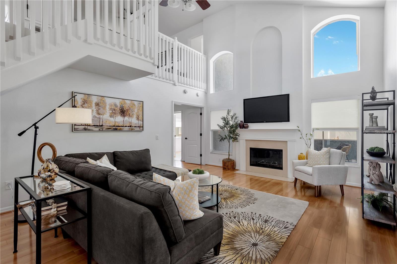 Grand livingroom with high ceilings & fireplace.