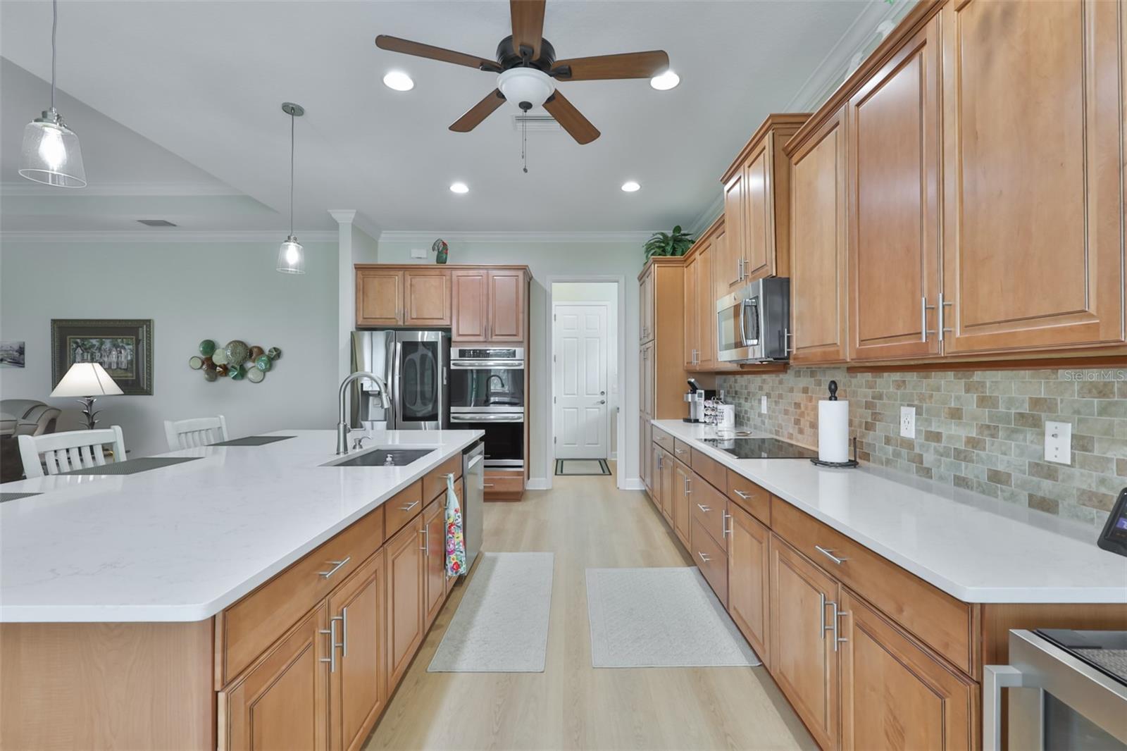 Stunning Quartz counter tops, all wood cabinetry in high demand Honey tones with pull out drawers, treys and soft close.