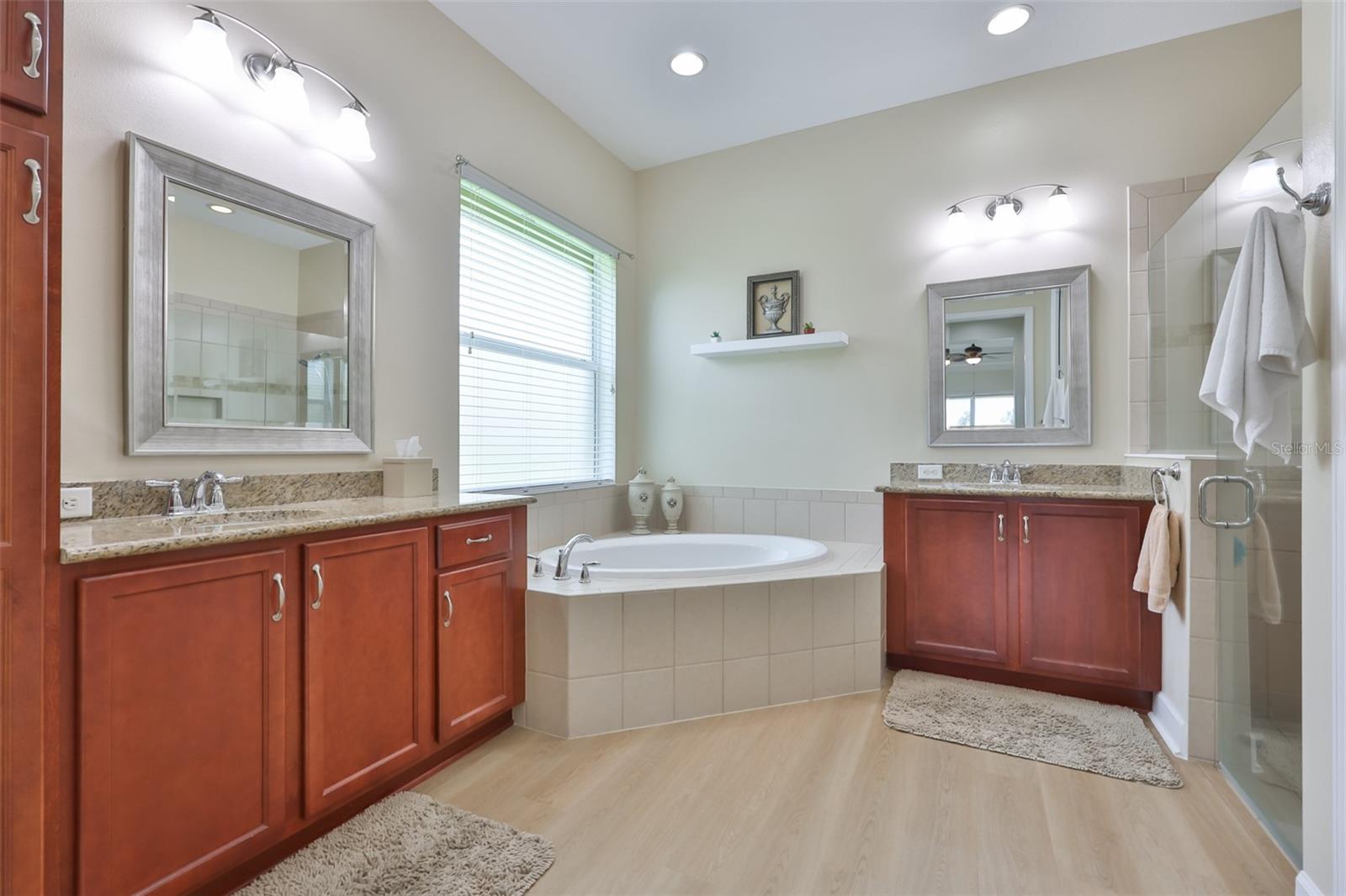 Large primary bathroom with beautiful cabinetry, large soaking tub, dual vanities and large walk in shower.