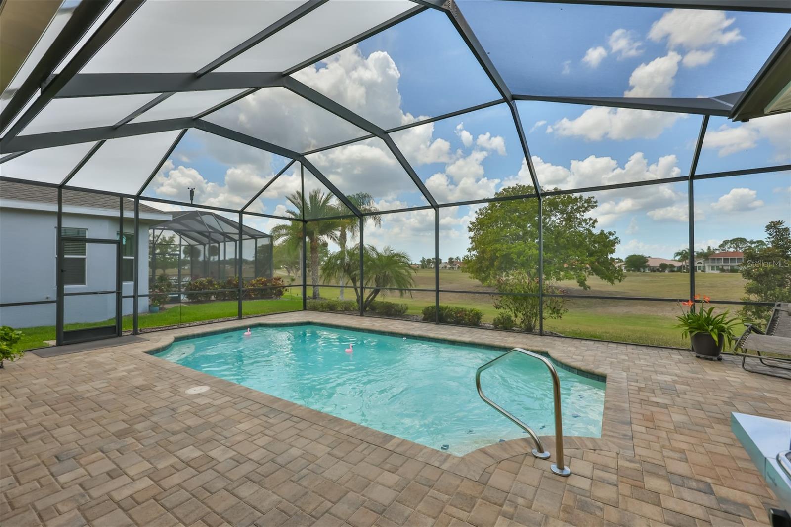 Large pebble tec lined pool is fully screened with NEW screen designed for 150 mph winds.