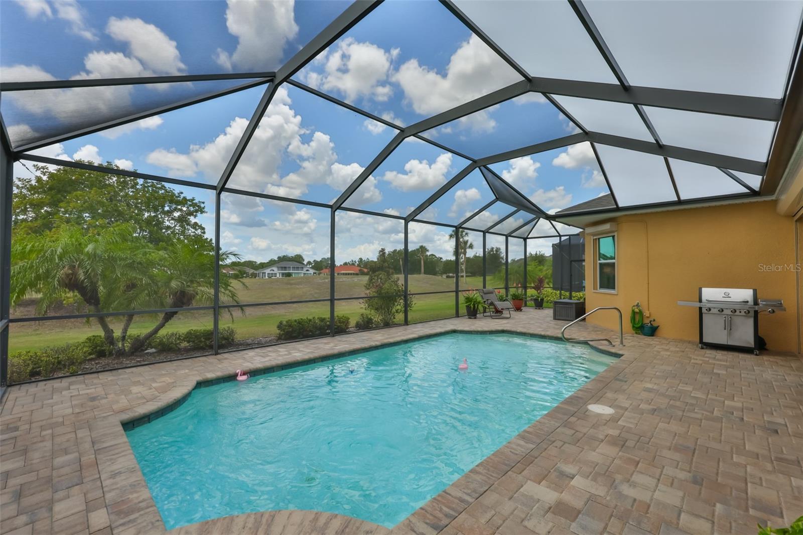 Custom brick pavers and "Florida Sun Screens" make this an elevated space for maximum enjoyment.
