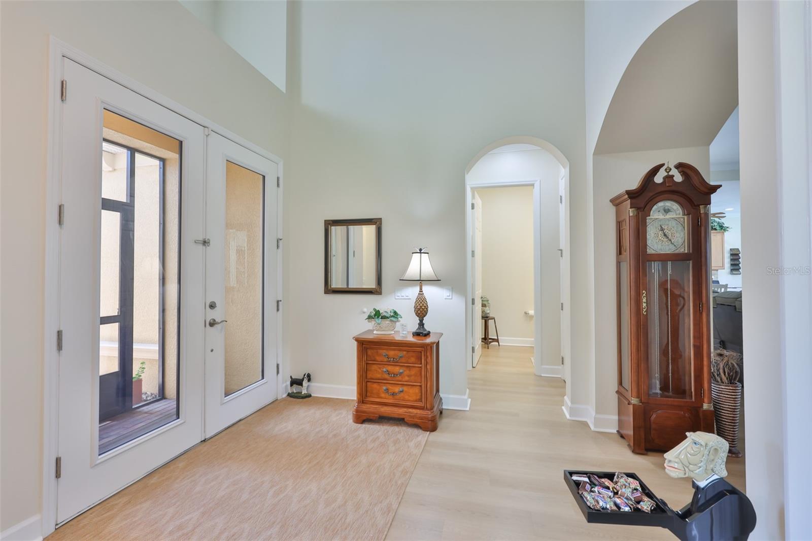 Screened entrance for guests to get out of the weather and a protected area for delivered packages, lead directly to the full glass doors and entry way into the home and a large open foyer.