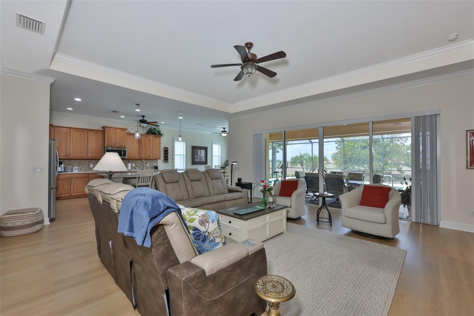 As you enter the home, you walk into the spacious open floor plan with multiple sliding glass doors that look out onto the screened lanai and the pool.