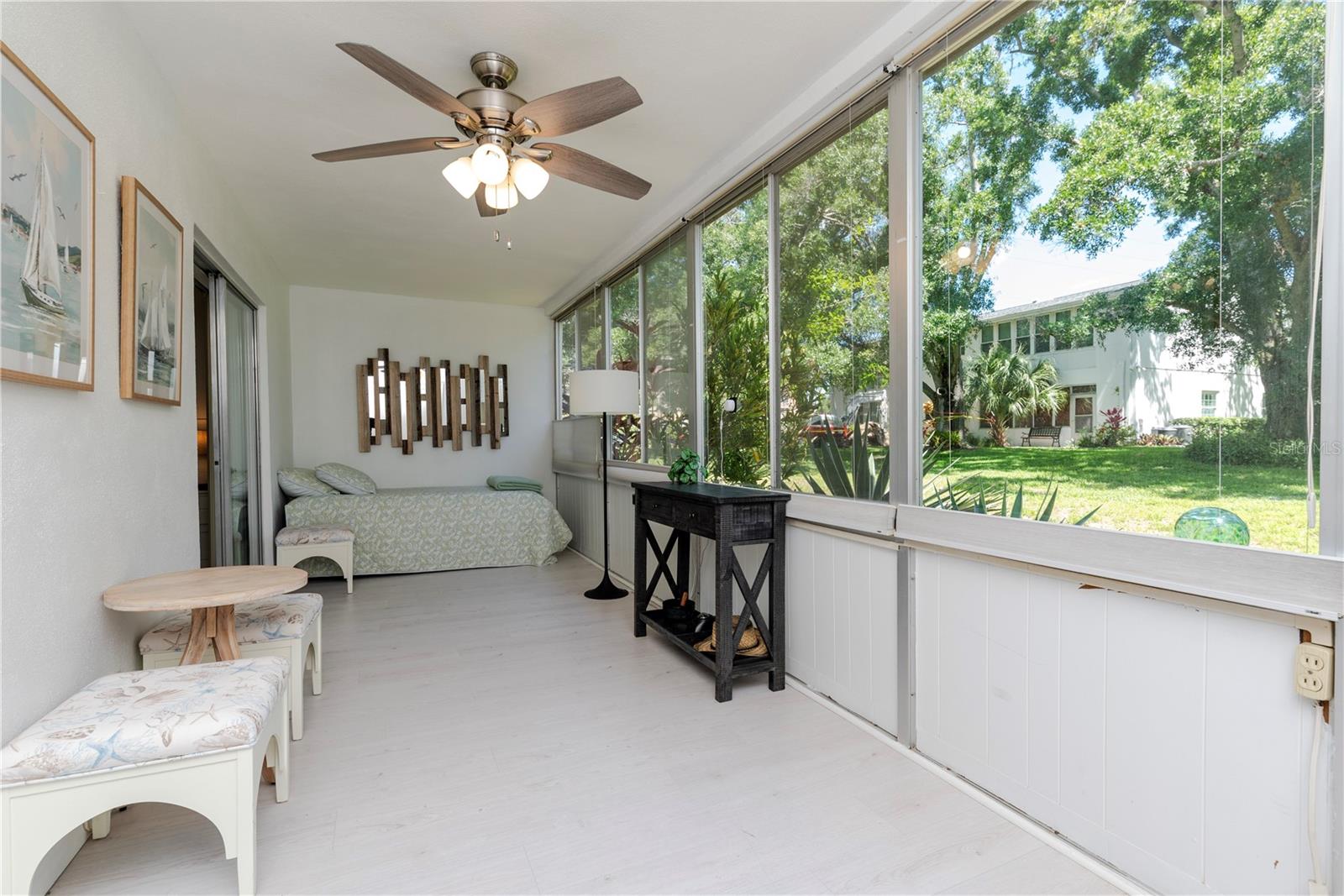 Enclosed porch with view of green space plus it has a storage closet.