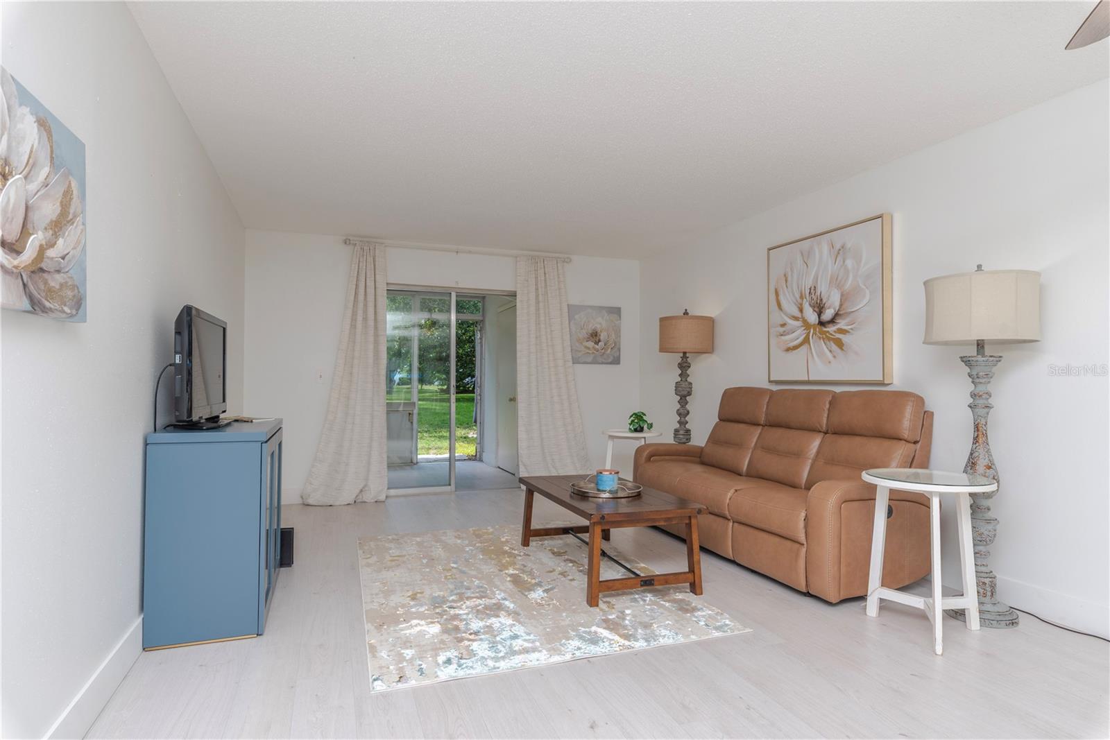 Living room opens to the enclosed porch.