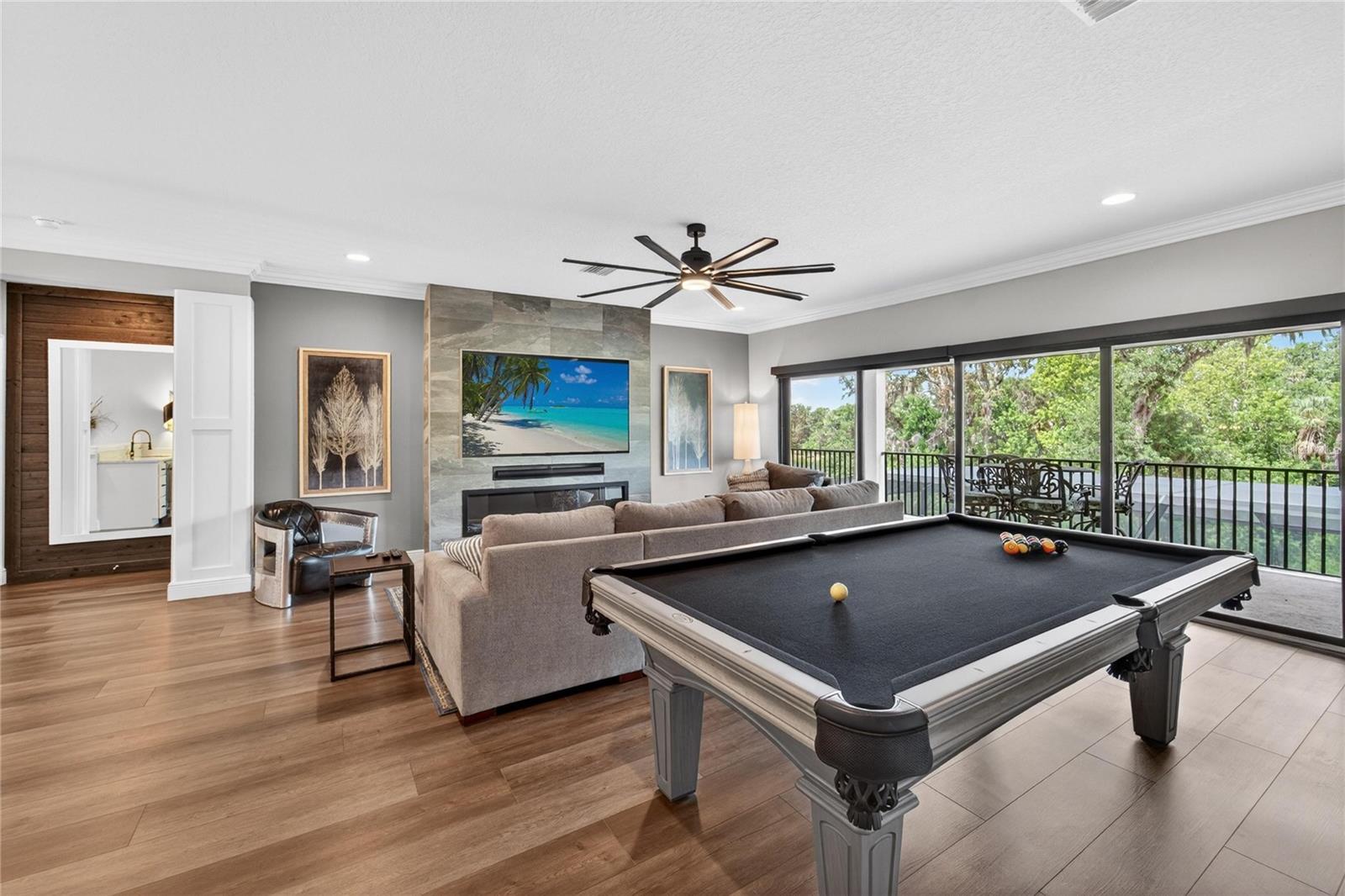 Upstairs bonus room with electric fireplace and auto curtain.