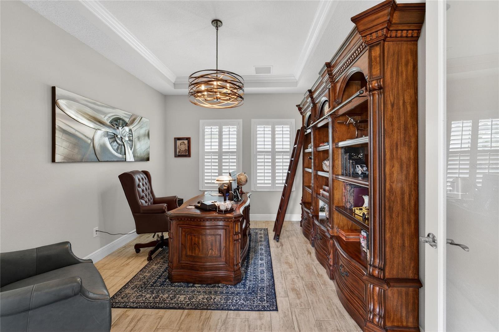Den which is used as an office with Tray ceilings.