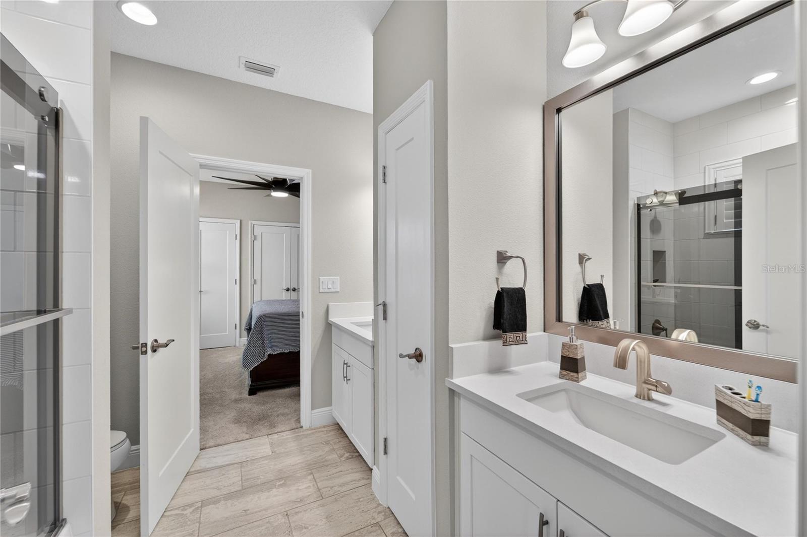 Bath with double sinks and jack and jill for bedrooms 2 and 3.