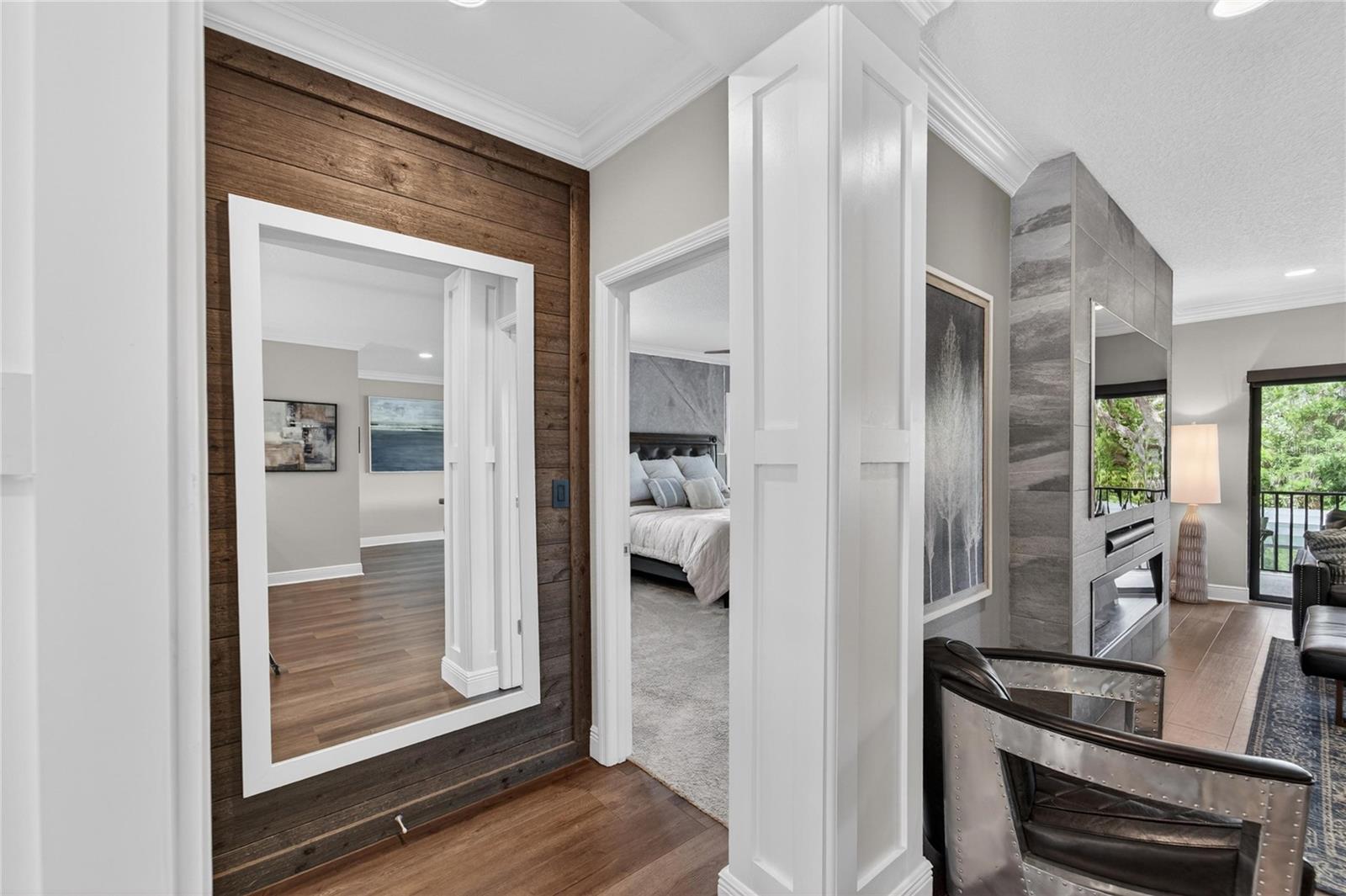 Accent wall with Shiplap and mirror and entry to the Owners Suite.