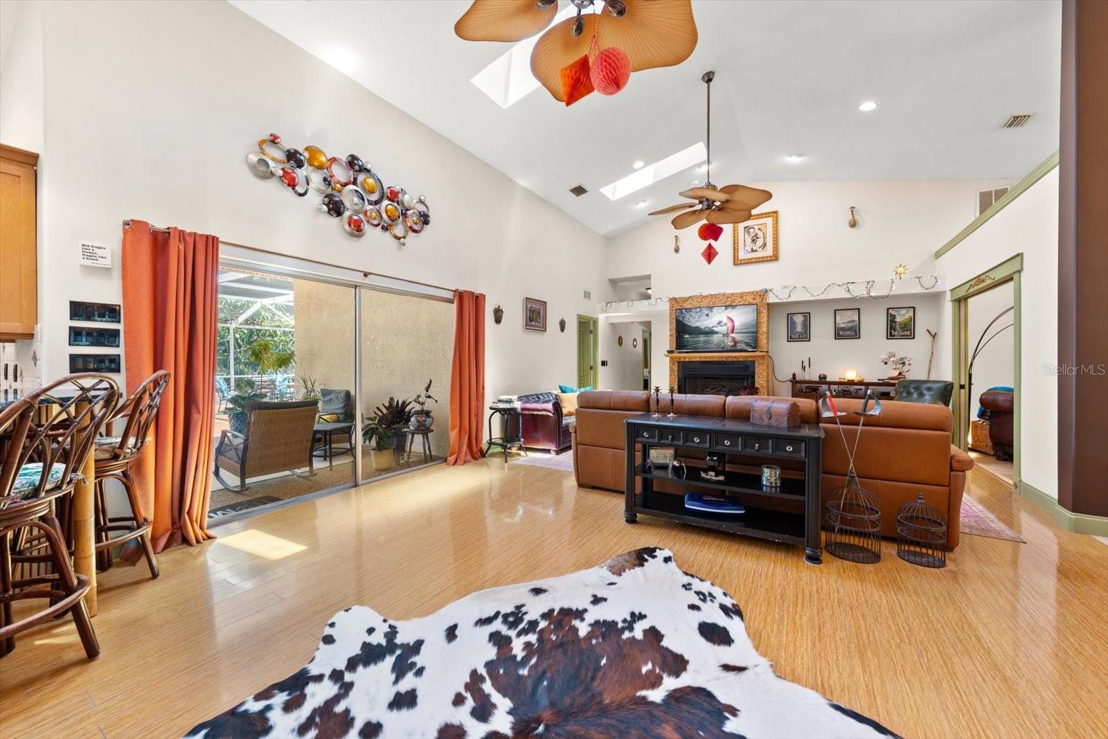 Great Room with view out to Pool, Gas Fireplace, and Vaulted Ceilings