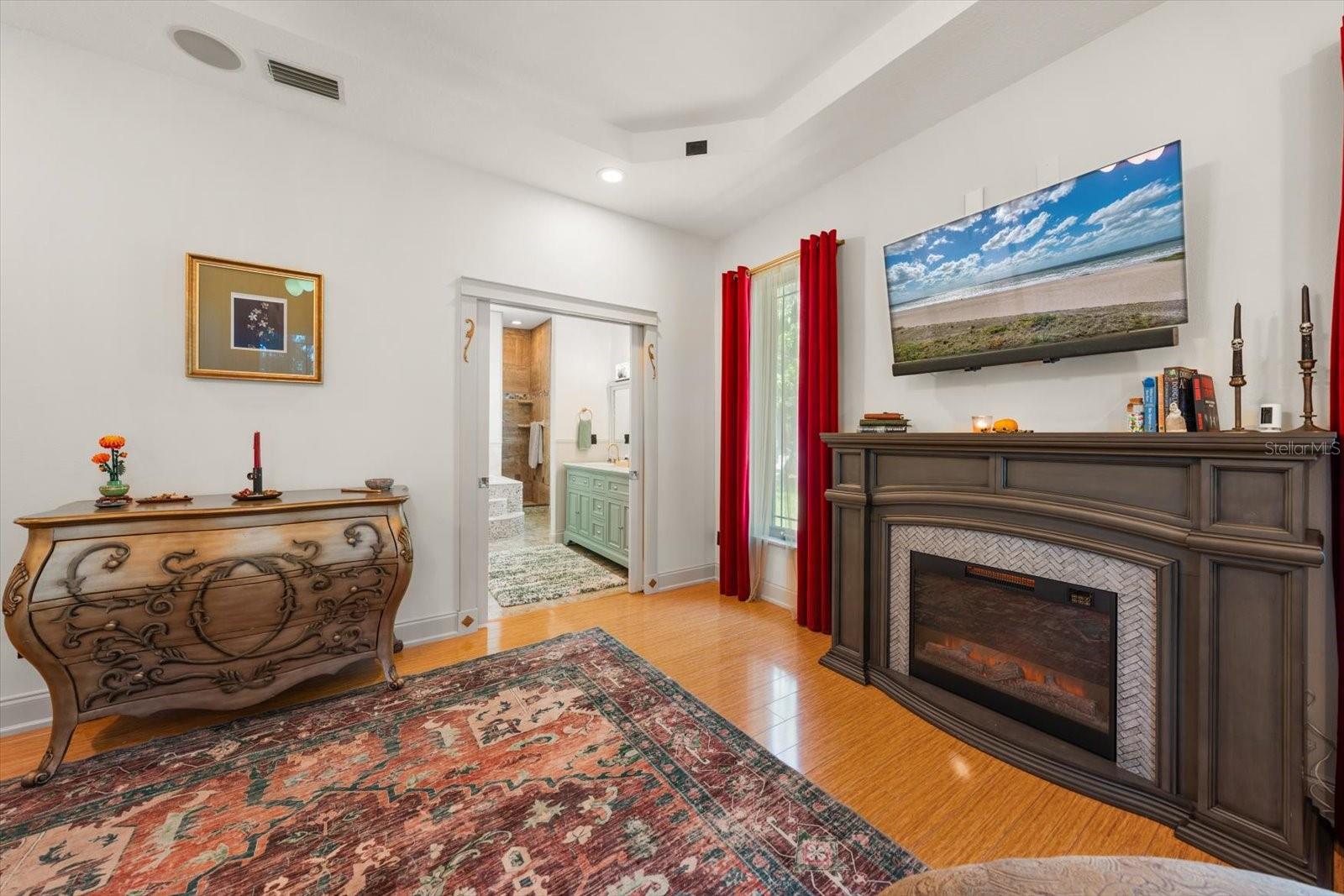 Fireplace in the Master with a View into the Master Bathroom