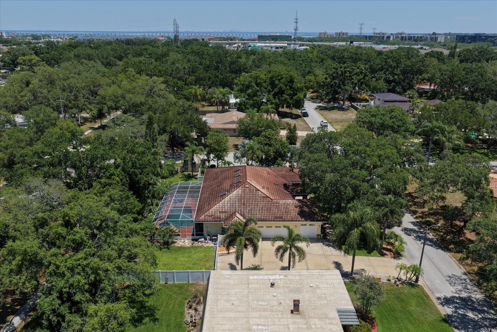 Ariel View of 3 Car Garage, enclosed Pool, and Yard
