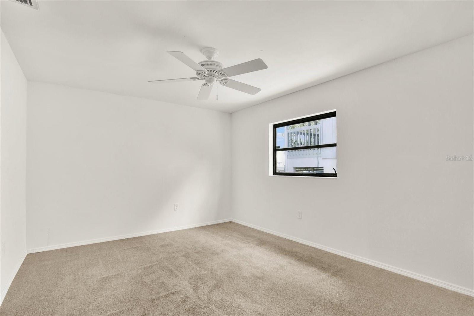 Bright and versatile second bedroom featuring a neutral pallet ready for any design.