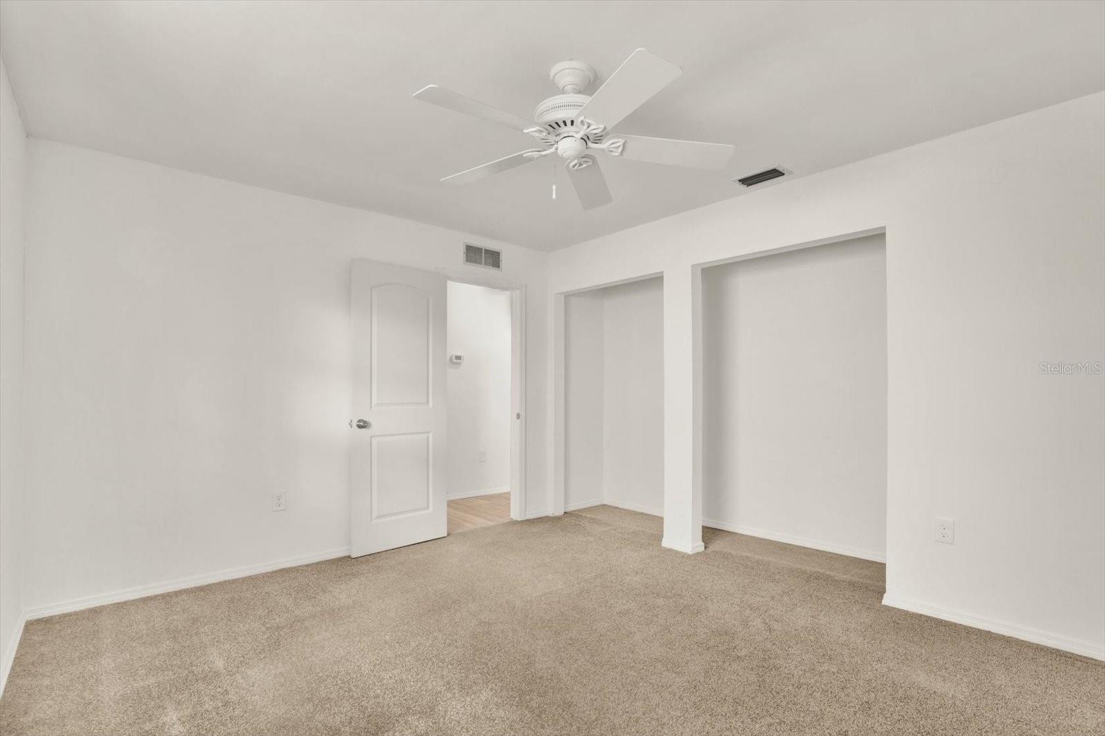 Additional view of second bedroom showcasing the spacious closet perfect for storage.