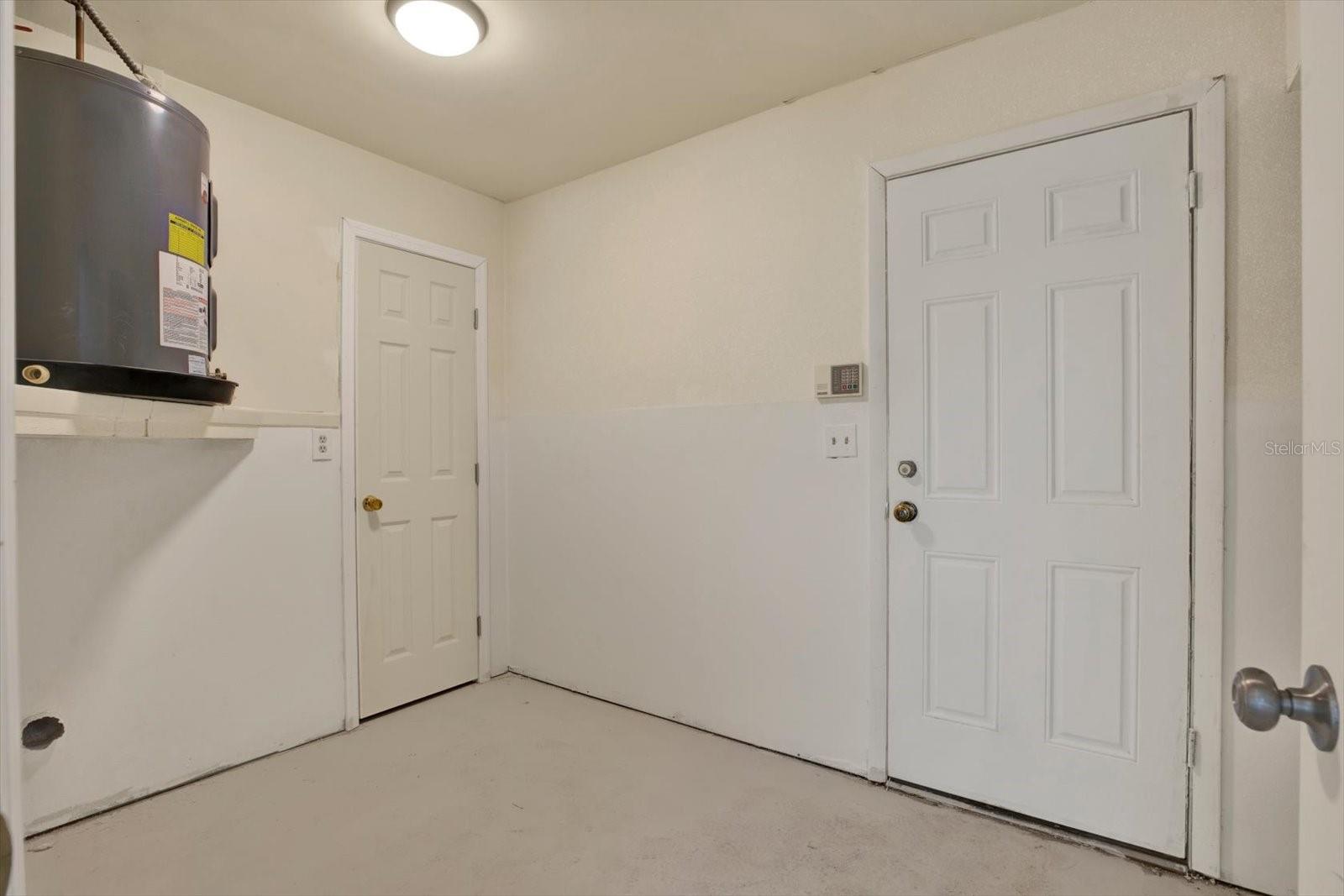 Convenient indoor laundry room offering dedicated space for standard washer and dryer hookups.