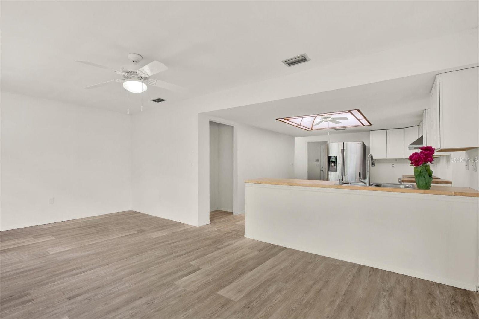 Open kitchen featuring stainless steel appliances, ample counter space, and a raised breakfast bar.