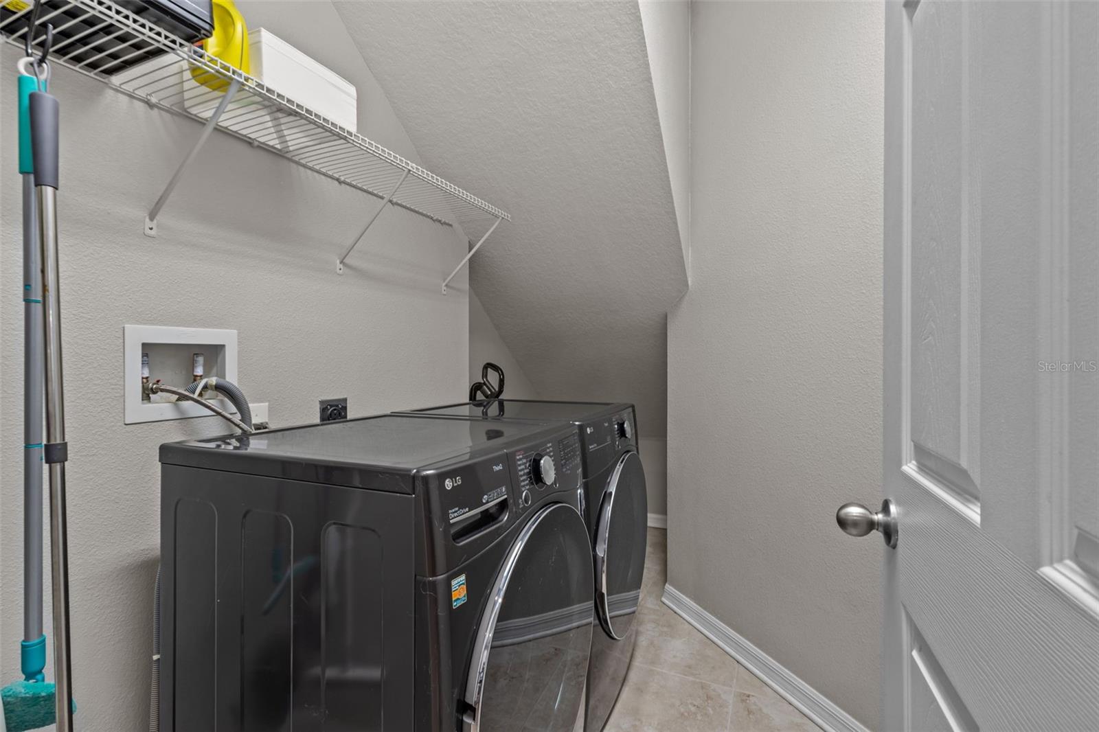 Convenient laundry room is located just off the kitchen and provides additional storage