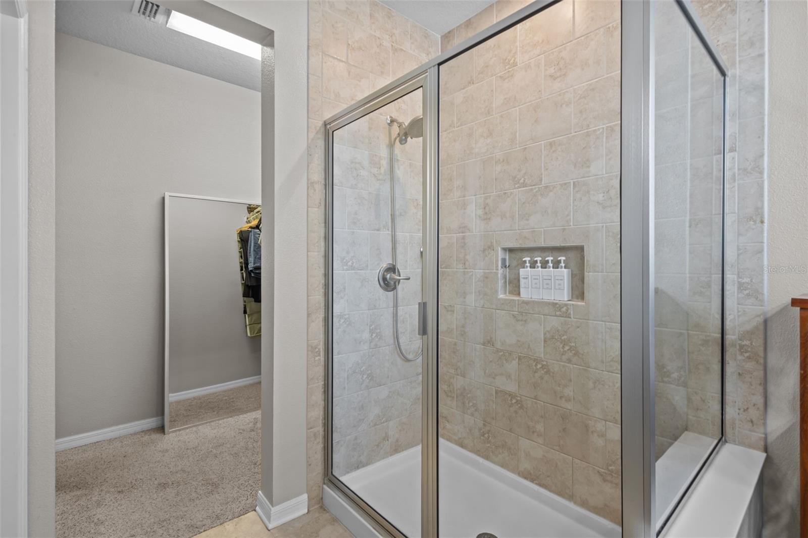 Primary bathroom features dual sinks, granite countertops, and a walk-in shower.
