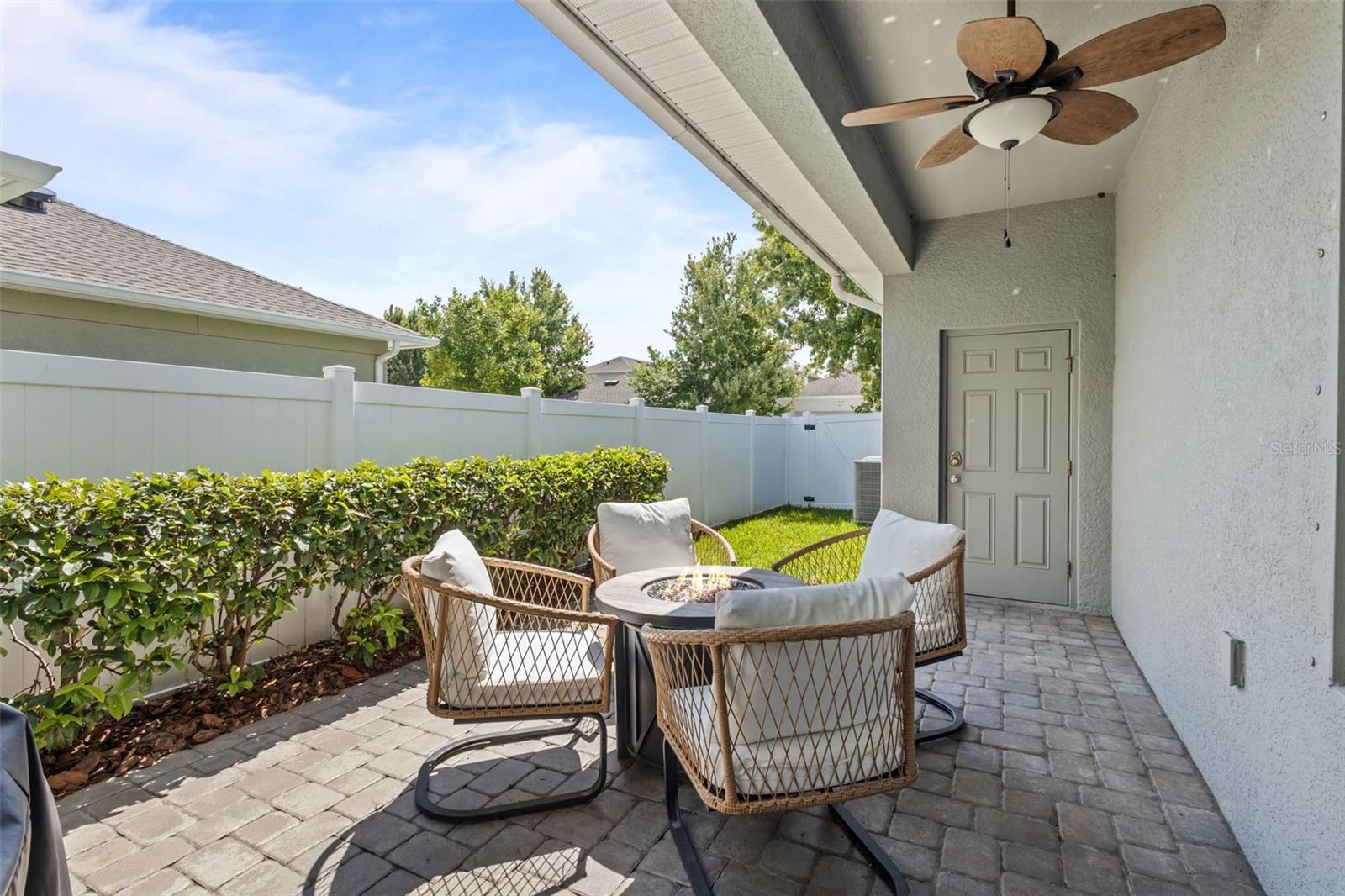 Rear exterior showcases the extended paver patio and detached garage