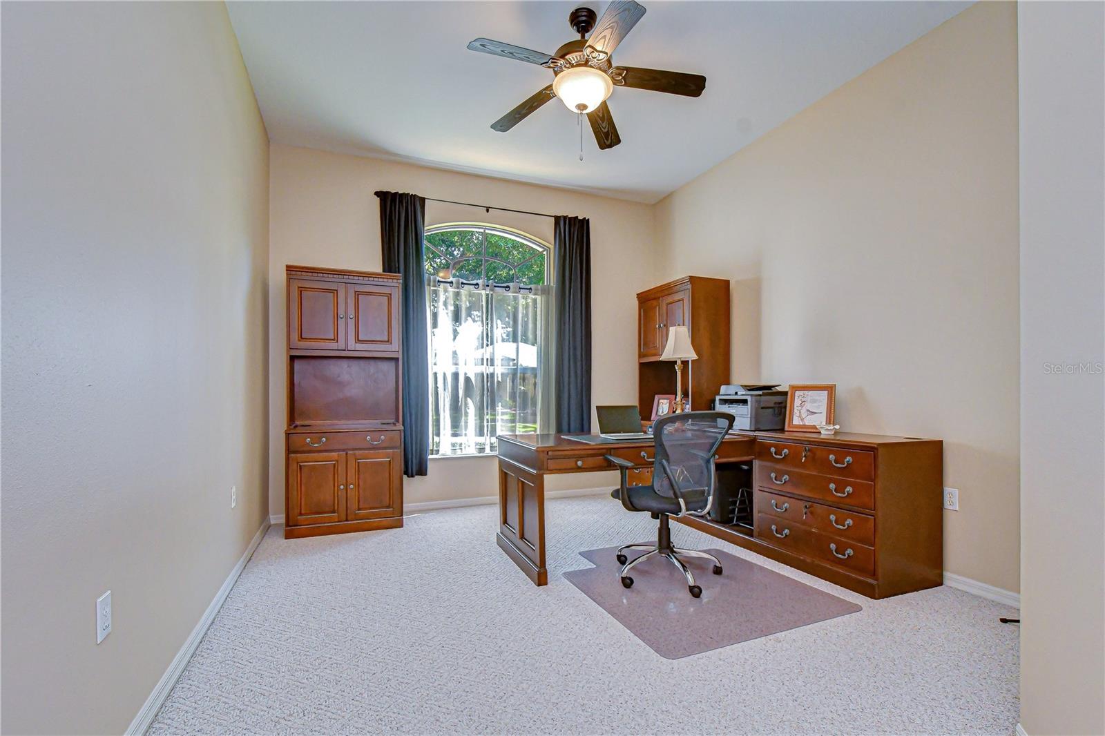 Dedicated office with closet for work-from-home convenience.