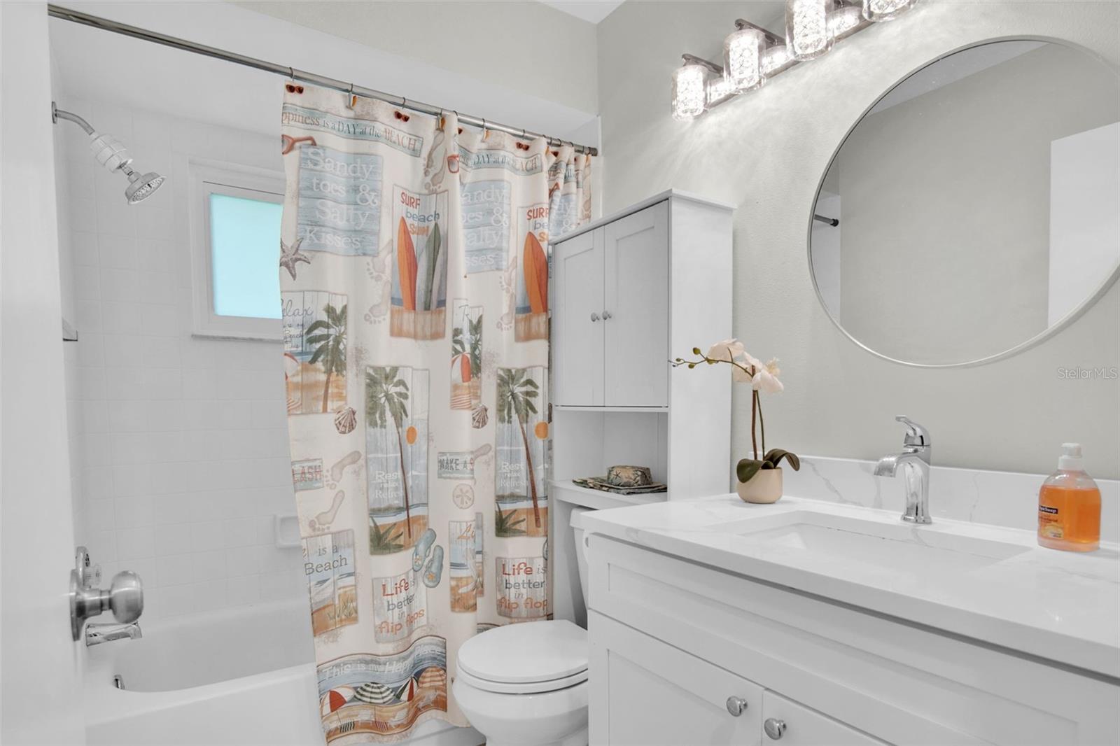 Beautiful hall bath with tub/shower combo conveniently located between the main living & guest suite~